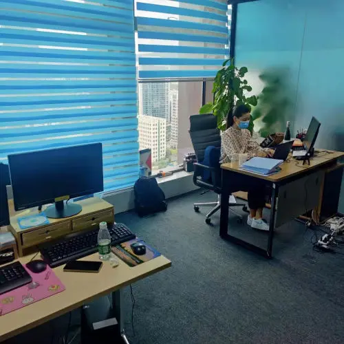 Xiao Bo sitting at her desk in the office
